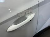a white car with a sticker on the door handle