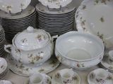 many plates and cups and saucers on the table
