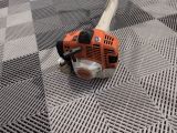 a chainsaw that is laying on a metal floor