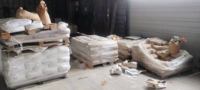 a pile of mattresses and other items in a room