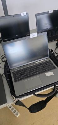 three laptops sitting on a desk with cords and cords