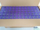 boxes of purple batteries are stacked on top of each other in a cardboard box