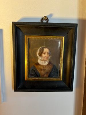 a painting of a woman in a black dress hanging on a wall
