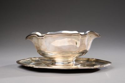 an antique silver plate with a saucer and a saucer on it