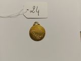 a close up of a gold coin on a white surface