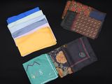 several different colored handkerchiefs laid out on a black surface