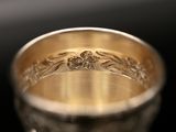 a close up of a silver cup on a black surface