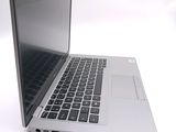 a silver laptop computer sitting on top of a white table