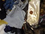 a pile of clothes and other items on a bed