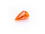 a close up of an orange sapphire stone on a white background