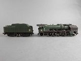 two toy trains sitting side by side on a white surface
