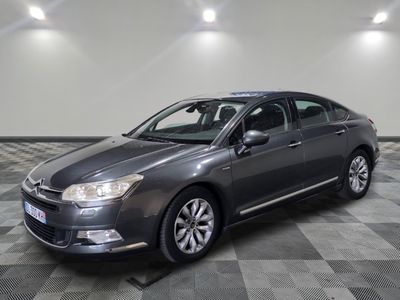 a picture of a grey car parked in a garage