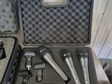 three microphones in a case sitting on a table