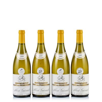 three bottles of white wine sitting next to each other on a white surface