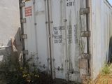 a white container sitting on the side of the road