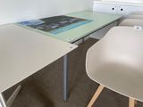 two chairs and a table with a magazine on it