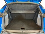 a trunk of a blue car with its doors open