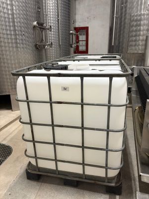 a large container sitting on top of a metal cart