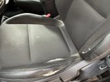 a dirty seat in the back of a car
