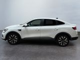 the white suv is parked in a room with a gray floor