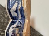 a blue and white vase sitting on top of a table