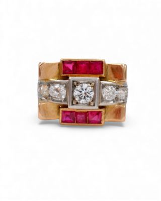 a close up of a diamond and ruby ring on a white background