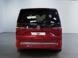 the back end of a red vw bus parked in a garage