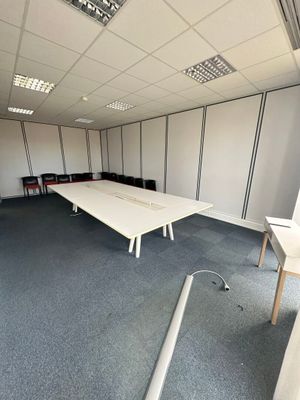 a room with a long table and chairs in it