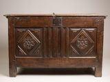 an old wooden chest with carvings on the front and sides