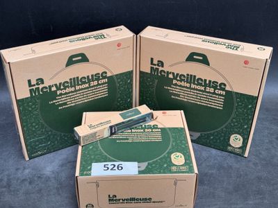 three boxes of medical equipment sitting on top of a blue surface