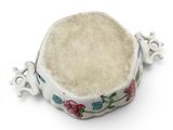 a small white bowl with a floral design on it