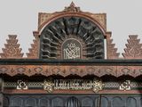 a clock on the top of a building with ornate carvings