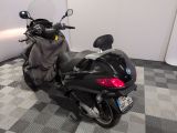 a black motorcycle parked in a room with a checkered floor