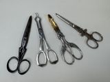 five pairs of scissors sitting next to each other on a table