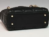 an image of a black purse on a white background