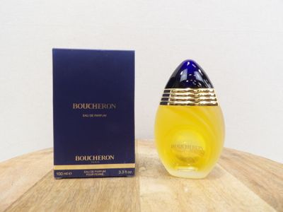 a close up of a bottle of perfume on a table