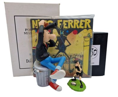 statue of a man sitting on top of a trash can next to a book