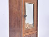 a small wooden cabinet with a mirror in it