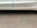 a picture of a white car parked on the side of the road