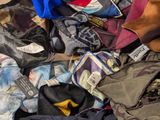 a pile of clothing that is sitting on the floor
