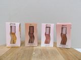 three boxes of perfume sitting on top of a wooden table