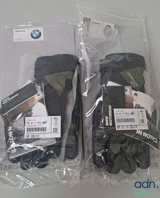 two pairs of gloves that are wrapped in plastic