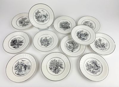 six plates with black and white designs are arranged on a white surface