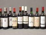 several bottles of wine are lined up on a table