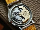 a close up of a watch with a yellow strap