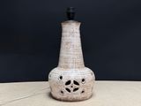 a white vase with a black top sitting on a table