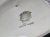 a close up of a white porcelain object with a label on it