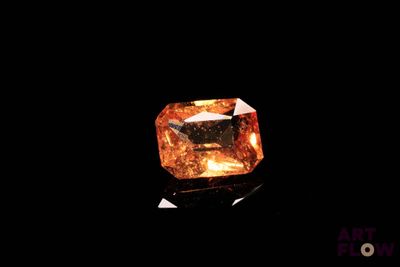 a close up of a yellow diamond on a black surface