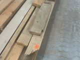 plusieurs pièces de bois sont empilées dans un entrepôt
