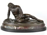 statue en bronze représentant un homme nu allongé sur un socle en marbre